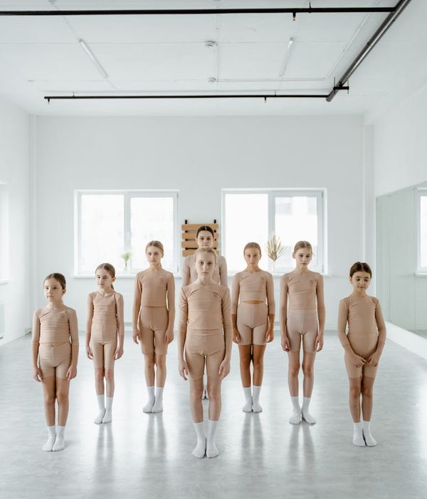 Woman performing a light cardio exercise in a calm studio environment.